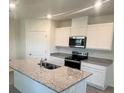 Modern kitchen with granite countertops, stainless steel appliances and a central island at 3641 Marlberry Way, Sanford, FL 32773