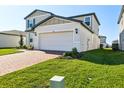 Well maintained two-story home featuring attached garage and brick paver driveway at 4514 Windy Oak Way, St Cloud, FL 34772