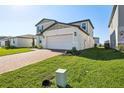 Well maintained two-story home featuring attached garage and brick paver driveway at 4514 Windy Oak Way, St Cloud, FL 34772