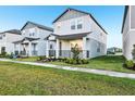 Row of modern gray homes with well-manicured lawns in a new community at 4673 Cross Prairie Pkwy, St Cloud, FL 34772