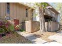 Charming home exterior featuring a unique wooden fenced entry and a mature tree at 4828 Pebble Beach Dr # A, Orlando, FL 32811