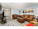 Comfortable living room with neutral colored sofas, decor, and wood look flooring at 4828 Pebble Beach Dr # A, Orlando, FL 32811