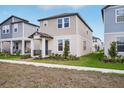 Lovely two-story home with a covered entry, situated on a well-maintained lawn in a residential area at 5099 Railroad Vine Aly, Winter Garden, FL 34787