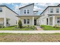 Charming two-story home featuring a quaint front porch, modern architectural details, and neatly manicured landscaping at 5106 Railroad Vine Aly, Winter Garden, FL 34787