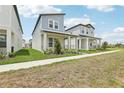 Quaint two-story homes line a sidewalk with front porches, modern architectural details and neatly manicured landscaping at 5106 Railroad Vine Aly, Winter Garden, FL 34787
