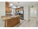 Open kitchen features a breakfast bar, stainless appliances, and tile flooring at 633 London Rd, Winter Park, FL 32792