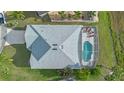 Aerial view showcasing the home, screened-in pool, and well-maintained surroundings at 647 Ella Mae Dr, Davenport, FL 33897
