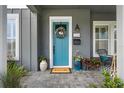 Welcoming front entrance with a blue door, stylish planters, and a modern exterior design at 1324 Utah Blvd, Orlando, FL 32803