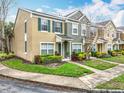 Exterior view showcasing the townhome's architecture and pleasant surroundings at 1410 Stockton Dr, Sanford, FL 32771