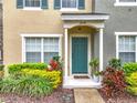 Close-up of front door with lush landscaping, providing curb appeal at 1410 Stockton Dr, Sanford, FL 32771