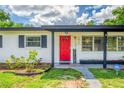 Close up of the front door, shutters, and house number of a charming single story home on a sunny day at 1412 Lakecrest Dr, Apopka, FL 32703