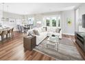 Spacious living room with hardwood floors, contemporary decor, and a seamless connection to the dining area at 16417 Silver Brook Way, Winter Garden, FL 34787