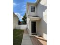 A welcoming doorway, and paved walkway framed by a well-maintained lawn and privacy fence at 1714 Sherbourne St, Winter Garden, FL 34787