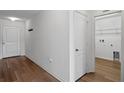 Hallway featuring a door to a laundry room with wire shelving at 1744 Wilson Prairie Cir, Groveland, FL 34736