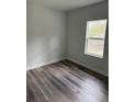 Simple bedroom design with wood-look flooring and a bright window offering outdoor views at 1926 Sw 160Th Sw Pl # 03, Ocala, FL 34470