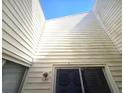 Exterior shot of the home's siding and windows, showing natural light entry points at 2452 Atrium Cir, Orlando, FL 32808