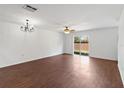 Bright living room featuring a ceiling fan, wood flooring, and a sliding glass door at 2913 Ashford Park Pl, Oviedo, FL 32765