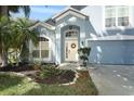 Beautiful home exterior with an arched entryway, white trim and lovely front yard landscaping at 324 Lusitano Way, Sanford, FL 32773