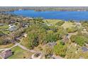 Stunning aerial view of a home nestled among lush trees near a serene lake, offering privacy and natural beauty at 33639 Wesley Rd, Eustis, FL 32736