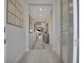 Bright hallway with recessed lights and tile flooring leading to the living areas of the house at 3704 Via Monte Napoleone Dr, Poinciana, FL 34759