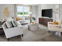 Comfortable living room featuring neutral tones, stylish furniture, and a large window at 3841 Giorgio Dr, Winter Haven, FL 33884