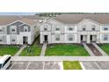 Street view of attractive townhomes with manicured lawns, paved walkways, and parking at 3974 Lana Ave, Davenport, FL 33897