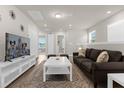 Inviting living room with neutral walls, plush sofa, and white accent furniture at 3974 Lana Ave, Davenport, FL 33897