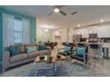 A modern and stylish living room featuring contemporary furniture, a blue accent wall and tile flooring at 4967 Windermere Ave, Kissimmee, FL 34746