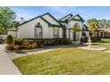 Well-landscaped home with beautiful flowerbeds and a charming water fountain in the front yard at 736 W Pinewood Ct, Lake Mary, FL 32746