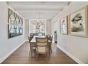 Elegant dining room featuring a chandelier, modern decor, and a hardwood floor at 7545 Laureate Blvd # 7203, Orlando, FL 32827