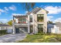 Beautiful two-story home with stone accents, modern garage door and balcony at 831 W Harvard St, Orlando, FL 32804