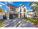 Beautiful two-story home with stone accents, modern garage door and balcony at 831 W Harvard St, Orlando, FL 32804