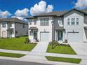 Charming two-story townhome with lush lawn, one-car garage, and inviting curb appeal at 929 Conch Rd, Davenport, FL 33896