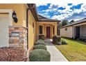 Charming single-story home with a well-kept lawn and manicured shrubs leading to the front entrance at 9472 Sw 76Th St, Ocala, FL 34481