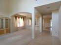 Bright entryway showcasing tile flooring, archways, and seamless transition into the carpeted living room at 1230 Elegance Ct, Orlando, FL 32828