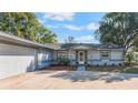 Inviting single-story house featuring a well-lit front entrance, complemented by a two-car garage at 172 Post And Rail Rd, Longwood, FL 32750