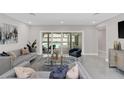 Elegant living room featuring stylish furniture and a seamless view of the pool at 2015 Summerfield Rd, Winter Park, FL 32792