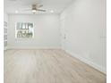 Bright, airy living room with light wood flooring, a ceiling fan, and a window with blinds at 230 Hennis Rd, Winter Garden, FL 34787