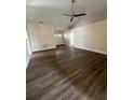 Spacious living room with modern wood-look floors, ceiling fan, and abundant natural light at 3224 Holland Dr, Orlando, FL 32825