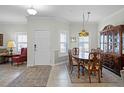 Traditional dining room showcasing a wood table, china cabinet, and natural lighting at 3543 Fairwaters Ct # D, Clermont, FL 34711