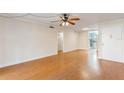 Open living room with hardwood floors, fan and neutral paint next to the kitchen at 4212 Lake Underhill Rd # 5, Orlando, FL 32803