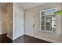 Bright entryway features a white door, window with blinds, and modern dark tile flooring at 4367 Thornbriar Ln # P204, Orlando, FL 32822