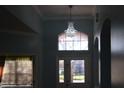 This is the entrance hall with the chandelier and windows by the front door overlooking the front yard at 4650 Redmond Pl, Sanford, FL 32771