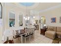 Elegant dining area with large mirrors, decorative ceiling dome, and stylish furnishings at 501 Sotheby Way, Debary, FL 32713