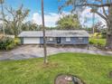 Quaint single-story home with a well-maintained lawn, tall trees, and a nautical themed boundary adding character at 607 Powers Ave, Port Orange, FL 32127