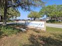 Community sign for Marina Lakefront Park near a street with parked cars, trees, and sunny skies at 618 Minnesota Ave, St Cloud, FL 34769