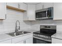 Updated kitchen featuring stainless steel appliances, subway tile backsplash, and ample counter space at 630 N Nashua Ave, Fort Meade, FL 33841