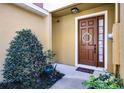 Inviting front entryway featuring a decorative wreath on the dark brown front door at 723 Marotta Loop, Ocoee, FL 34761