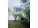 View of yard showing lush plants in pots and other garden features at 7531 Marietta St, Orlando, FL 32807