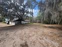 Overgrown lot filled with fallen leaves, perfect for landscaping projects at 8801 Hackney Prairie Rd, Orlando, FL 32818